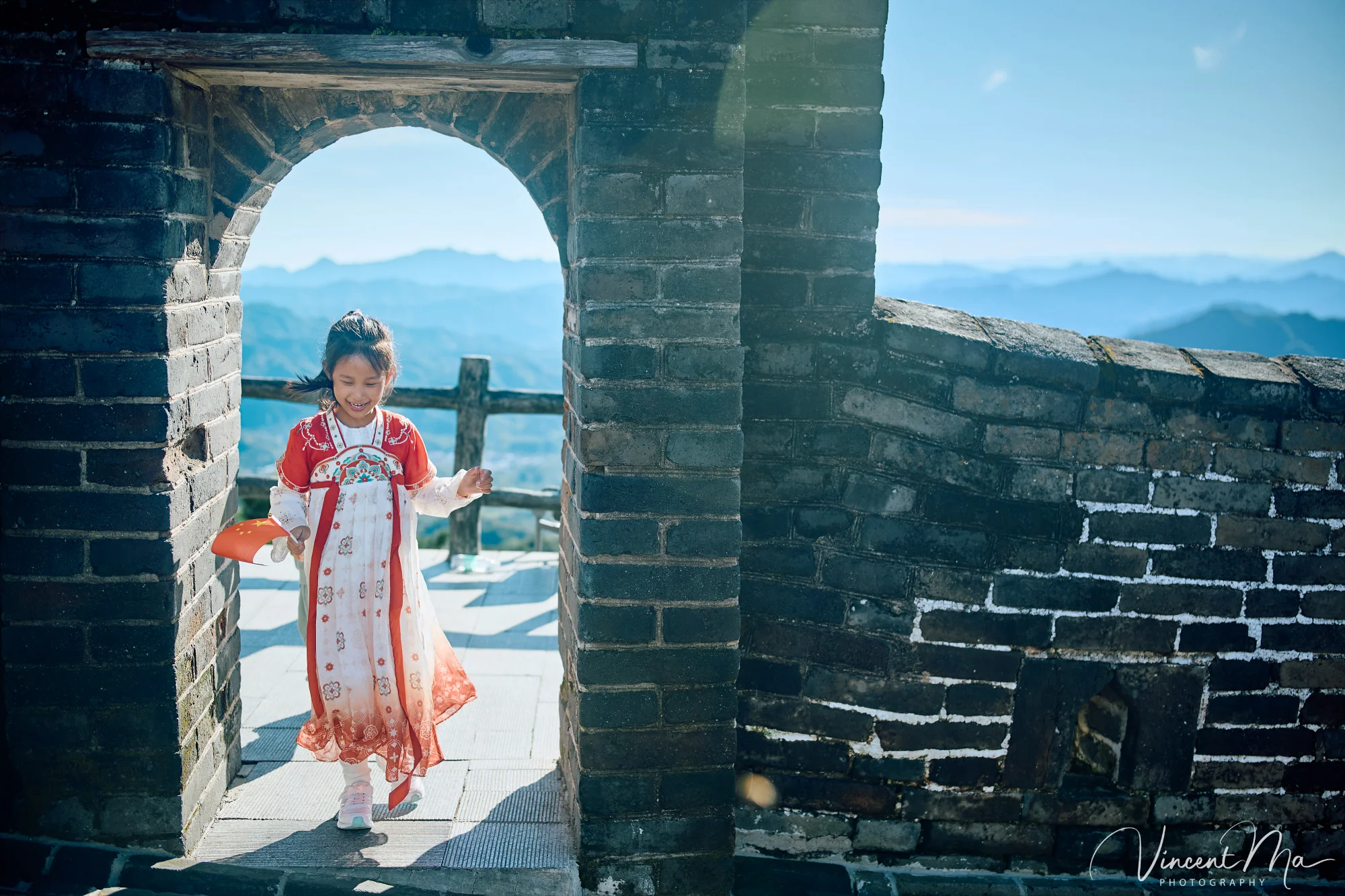 A panoramic view of the Mutianyu Great Wall during a family trip in the afternoon, showing the majestic wall winding through the mountains