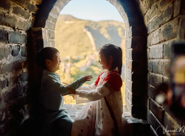 A panoramic view of the Mutianyu Great Wall during a family trip in the afternoon, showing the majestic wall winding through the mountains