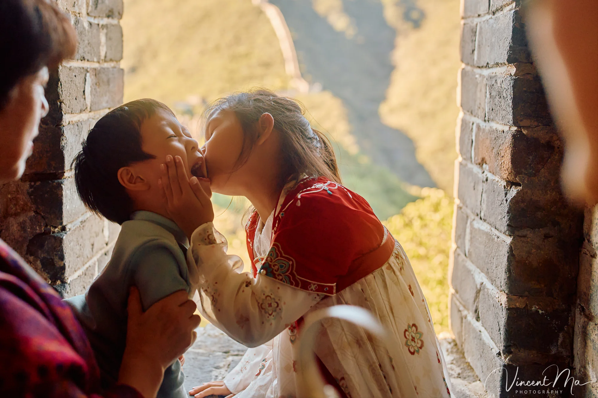 A panoramic view of the Mutianyu Great Wall during a family trip in the afternoon, showing the majestic wall winding through the mountains