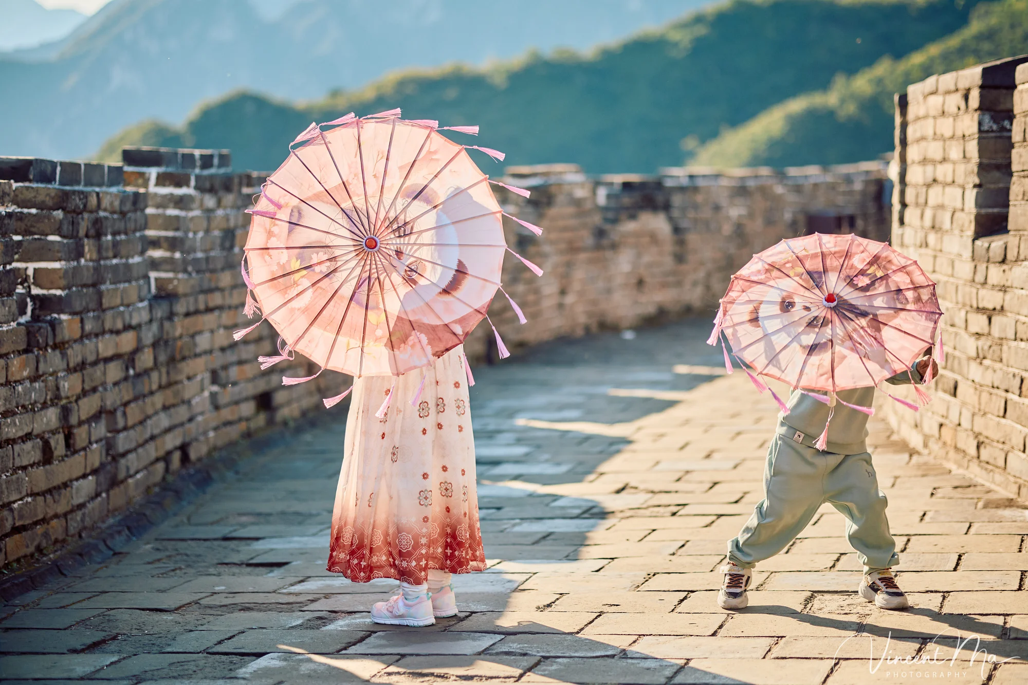 A panoramic view of the Mutianyu Great Wall during a family trip in the afternoon, showing the majestic wall winding through the mountains
