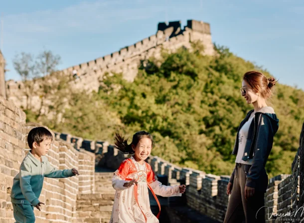 A panoramic view of the Mutianyu Great Wall during a family trip in the afternoon, showing the majestic wall winding through the mountains