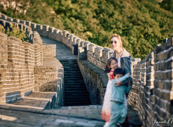 A panoramic view of the Mutianyu Great Wall during a family trip in the afternoon, showing the majestic wall winding through the mountains