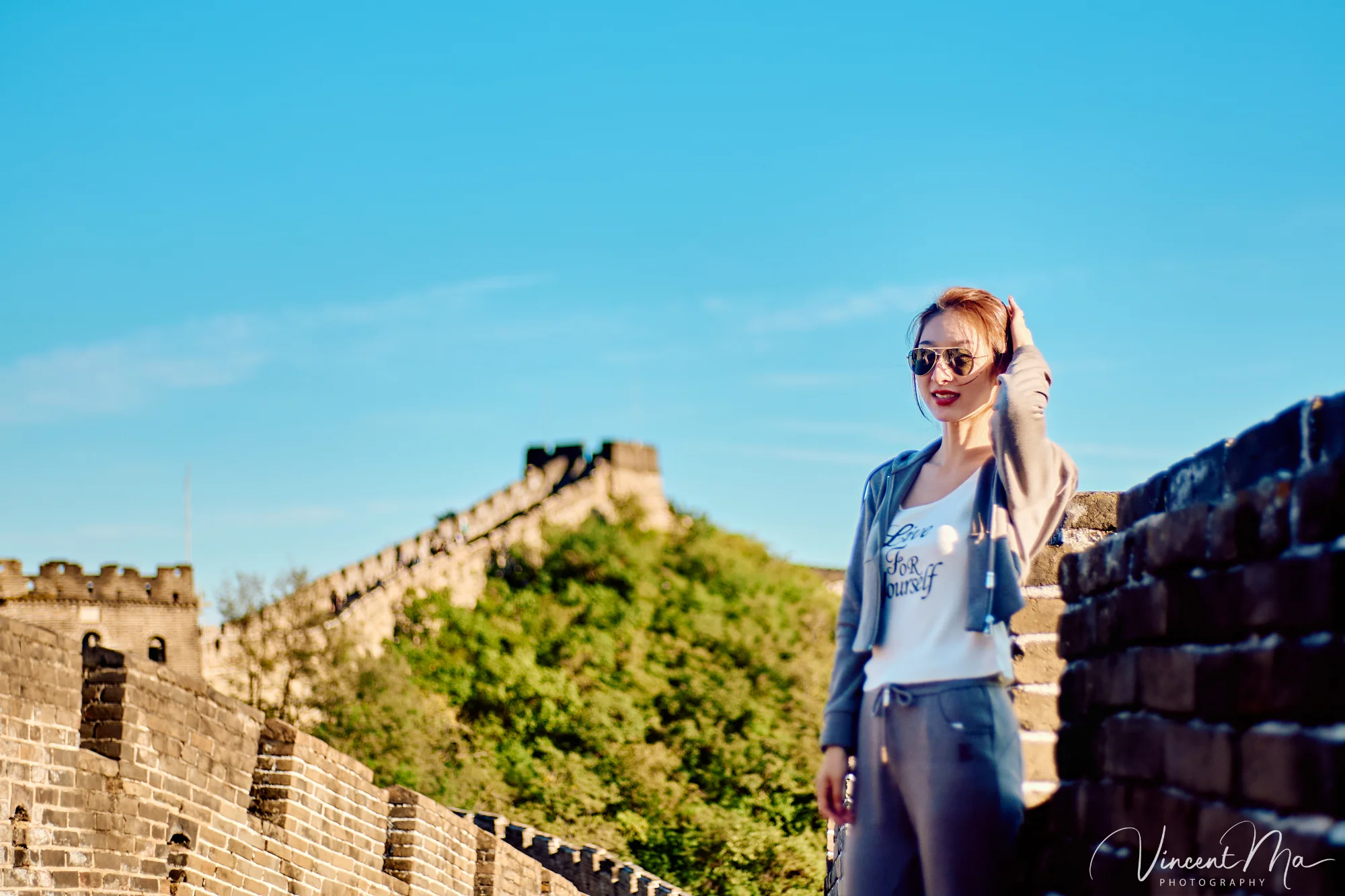 A panoramic view of the Mutianyu Great Wall during a family trip in the afternoon, showing the majestic wall winding through the mountains