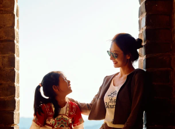 A panoramic view of the Mutianyu Great Wall during a family trip in the afternoon, showing the majestic wall winding through the mountains