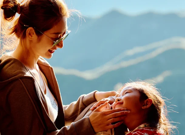 A panoramic view of the Mutianyu Great Wall during a family trip in the afternoon, showing the majestic wall winding through the mountains