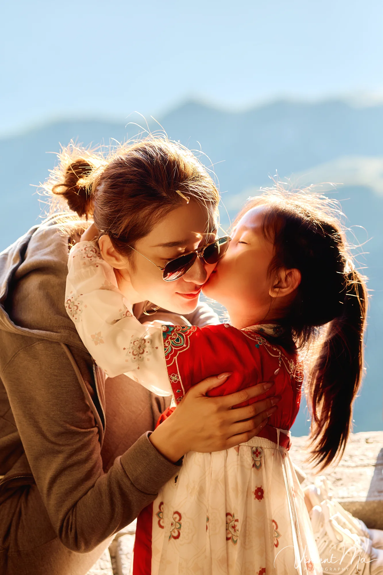 A panoramic view of the Mutianyu Great Wall during a family trip in the afternoon, showing the majestic wall winding through the mountains