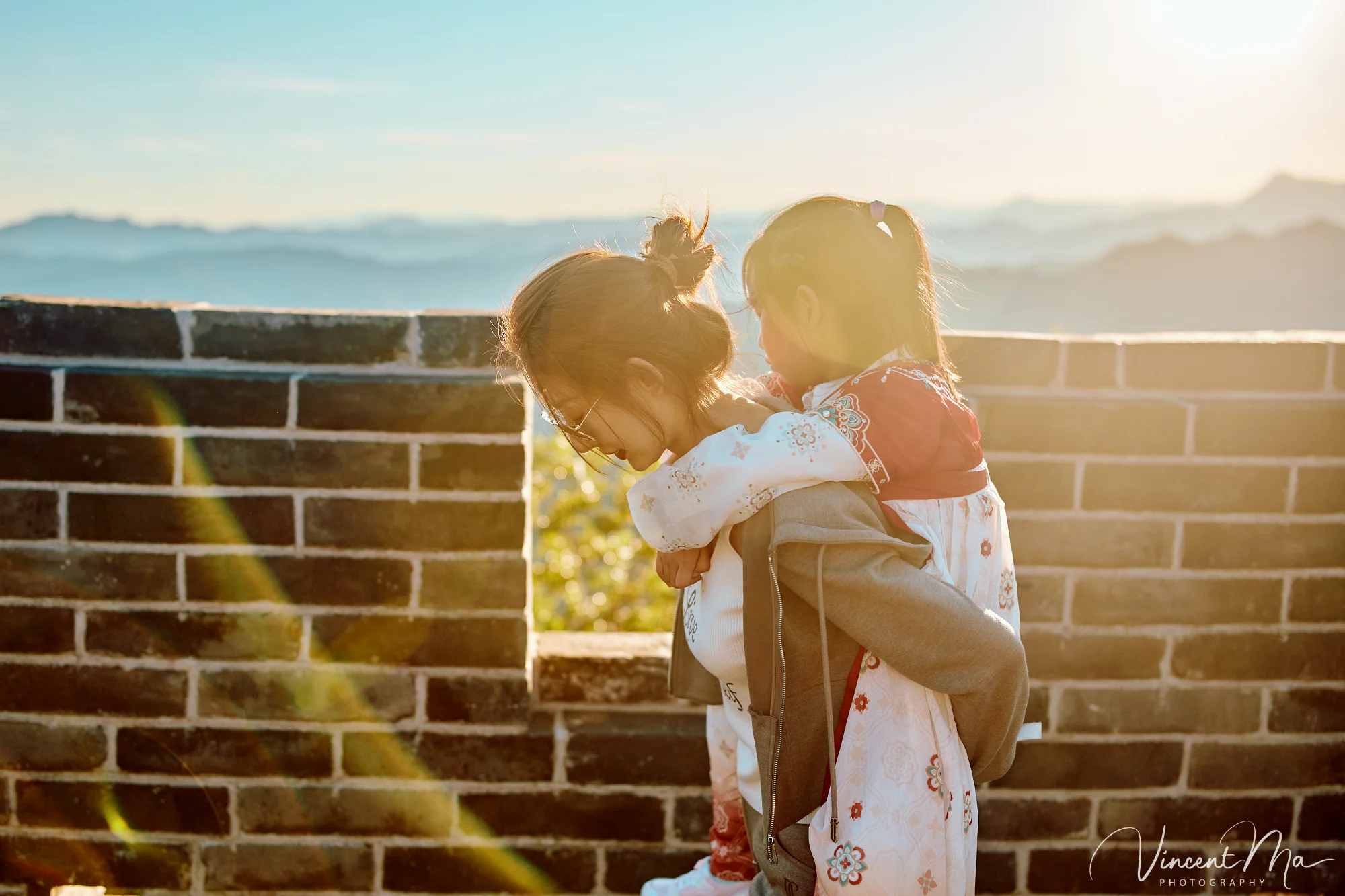 A panoramic view of the Mutianyu Great Wall during a family trip in the afternoon, showing the majestic wall winding through the mountains