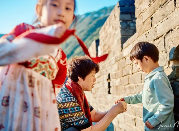 A panoramic view of the Mutianyu Great Wall during a family trip in the afternoon, showing the majestic wall winding through the mountains