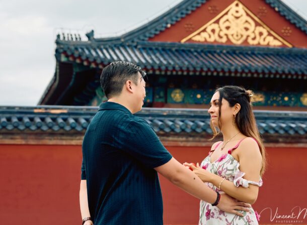 A foreign couple in traditional Chinese - style clothing, the man kneeling on one knee to propose to the woman in front of the majestic Hall of Prayer for Good Harvests in the Temple of Heaven
