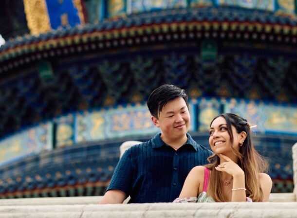 A foreign couple in traditional Chinese - style clothing, the man kneeling on one knee to propose to the woman in front of the majestic Hall of Prayer for Good Harvests in the Temple of Heaven