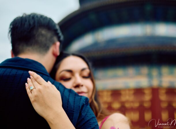 A foreign couple in traditional Chinese - style clothing, the man kneeling on one knee to propose to the woman in front of the majestic Hall of Prayer for Good Harvests in the Temple of Heaven