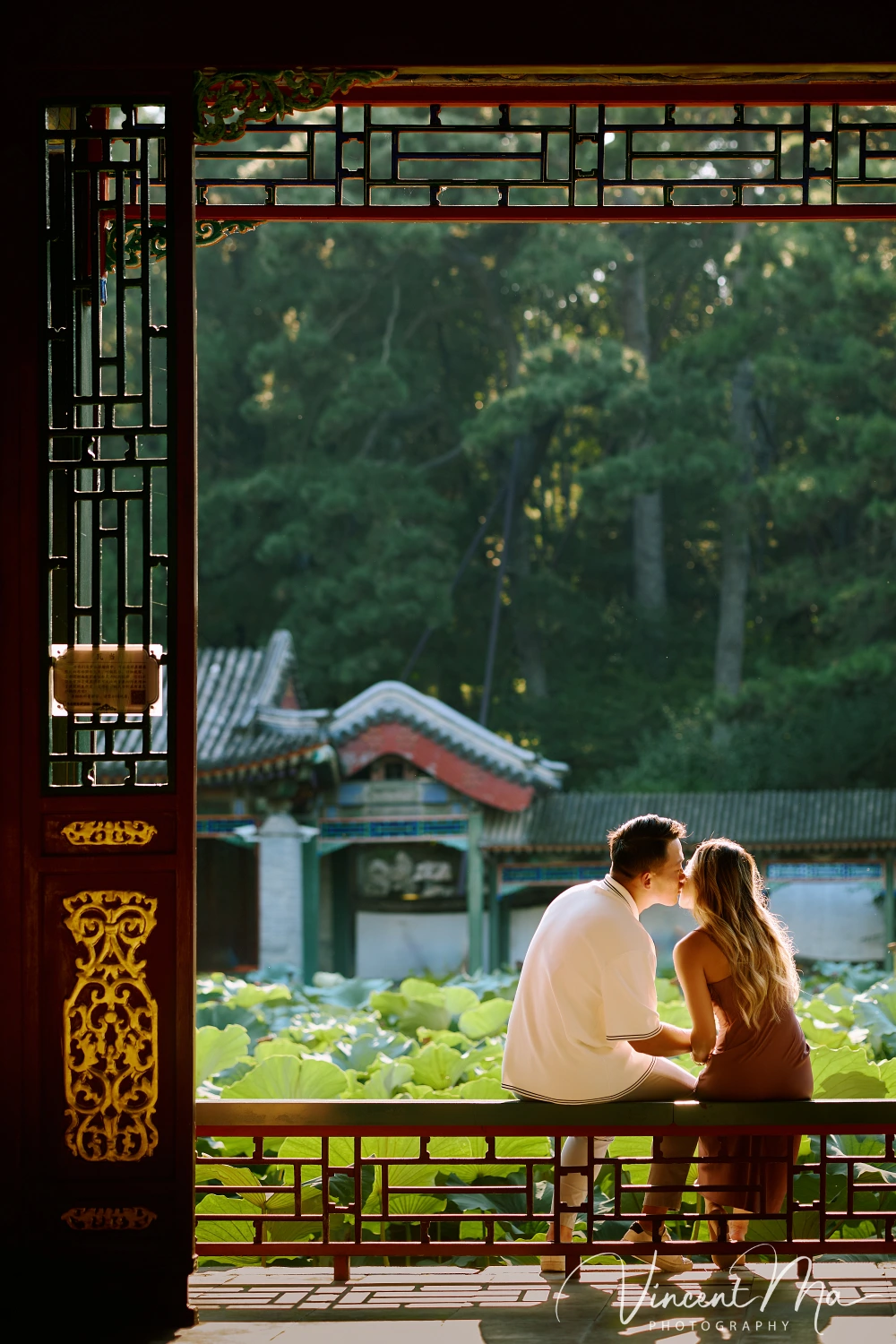 Couple enjoying a romantic moment at the Garden of Harmonious Interests in Beijing's Summer Palace, surrounded by traditional Chinese garden scenery with lakes and pavilions. Engagement shooting in summer palace. 