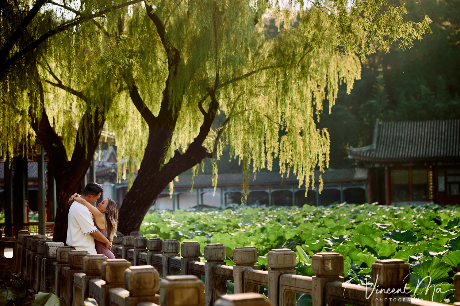 Couple enjoying a romantic moment at the Garden of Harmonious Interests in Beijing's Summer Palace, surrounded by traditional Chinese garden scenery with lakes and pavilions. Engagement shooting in summer palace. 