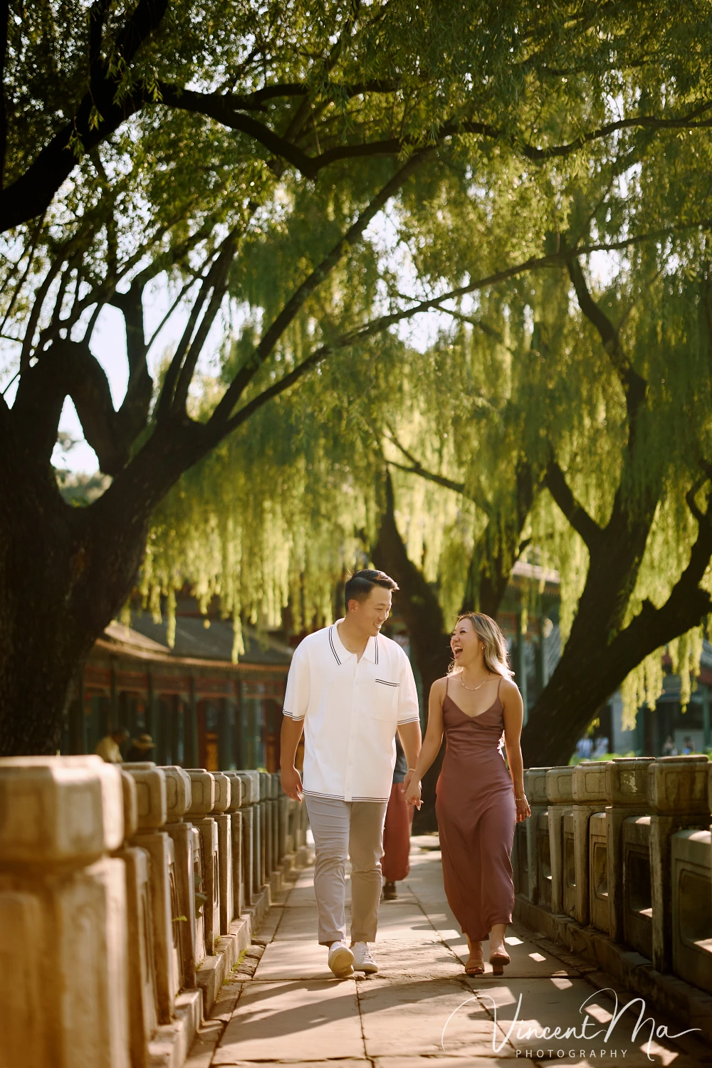 Couple enjoying a romantic moment at the Garden of Harmonious Interests in Beijing's Summer Palace, surrounded by traditional Chinese garden scenery with lakes and pavilions. Engagement shooting in summer palace. 