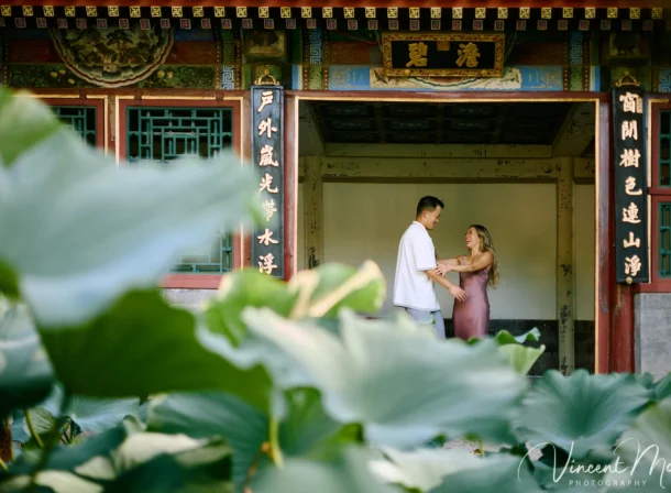 Couple enjoying a romantic moment at the Garden of Harmonious Interests in Beijing's Summer Palace, surrounded by traditional Chinese garden scenery with lakes and pavilions. Engagement shooting in summer palace.