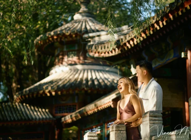 Couple enjoying a romantic moment at the Garden of Harmonious Interests in Beijing's Summer Palace, surrounded by traditional Chinese garden scenery with lakes and pavilions. Engagement shooting in summer palace.