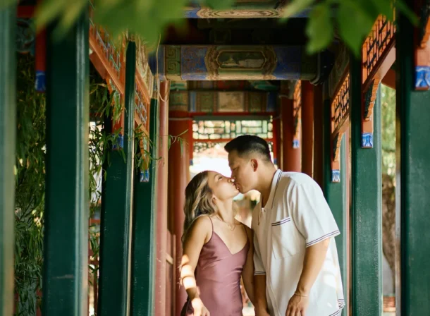 Couple enjoying a romantic moment at the Garden of Harmonious Interests in Beijing's Summer Palace, surrounded by traditional Chinese garden scenery with lakes and pavilions. Engagement shooting in summer palace.