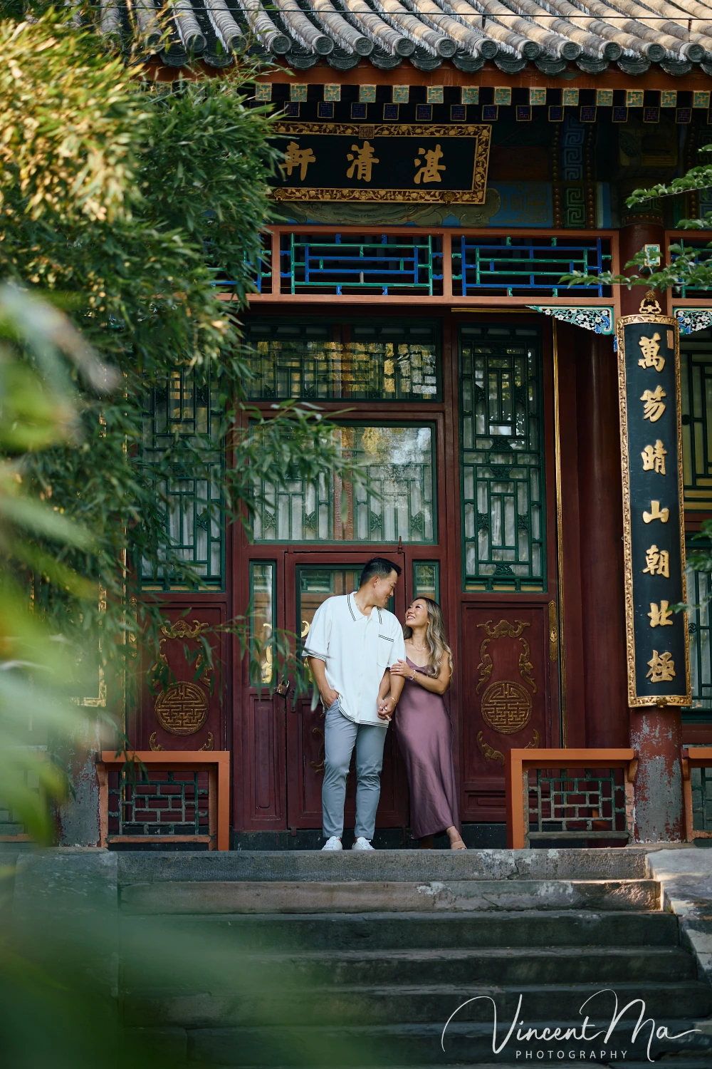 Couple enjoying a romantic moment at the Garden of Harmonious Interests in Beijing's Summer Palace, surrounded by traditional Chinese garden scenery with lakes and pavilions. Engagement shooting in summer palace. 