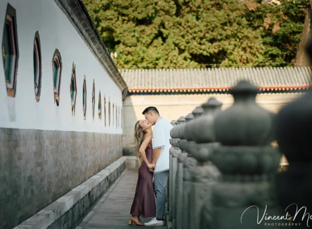 Couple enjoying a romantic moment at The Long Corridor in Beijing's Summer Palace, surrounded by traditional Chinese garden scenery with lakes and pavilions. Engagement shooting in summer palace.