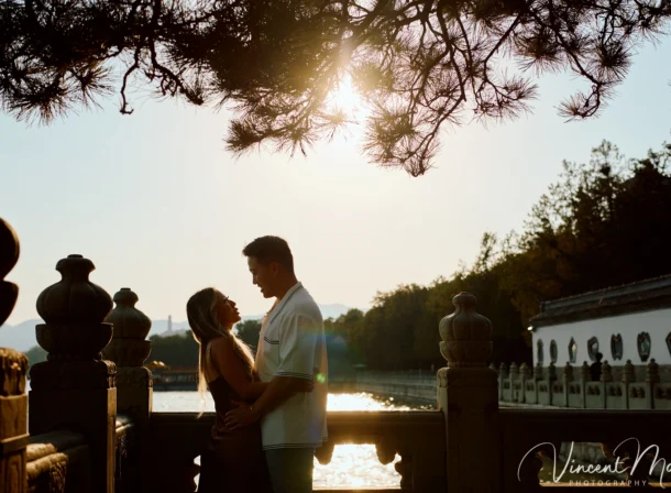 Couple enjoying a romantic moment at The Long Corridor in Beijing's Summer Palace, surrounded by traditional Chinese garden scenery with lakes and pavilions. Engagement shooting in summer palace.
