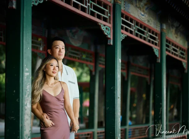 Couple enjoying a romantic moment at The Long Corridor in Beijing's Summer Palace, surrounded by traditional Chinese garden scenery with lakes and pavilions. Engagement shooting in summer palace.