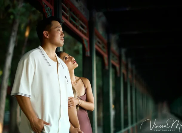 Couple enjoying a romantic moment at The Long Corridor in Beijing's Summer Palace, surrounded by traditional Chinese garden scenery with lakes and pavilions. Engagement shooting in summer palace.