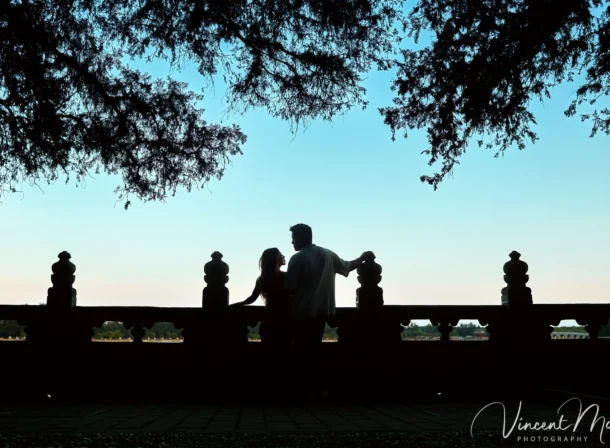 A couple shares an intimate moment with the magnificent architecture of the Summer Palace in sunset in the background.