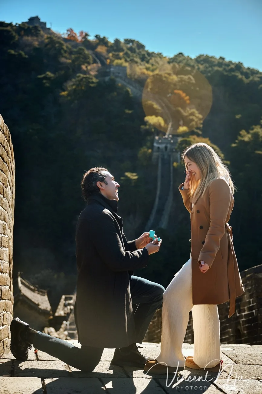 Man proposing to woman on Mutianyu Great Wall during autumn with mountains in background.Beijing photoshoot-Beijing photographer
