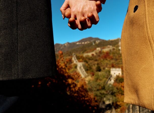 Surprise marriage proposal engagement shooting on Mutianyu Great Wall with ancient bricks and autumn leaves in background