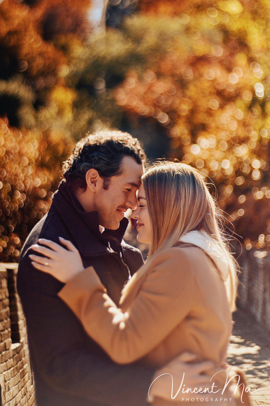 Surprise marriage proposal engagement shooting on Mutianyu Great Wall with ancient bricks and autumn leaves in background