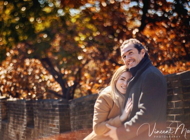 Surprise marriage proposal engagement shooting on Mutianyu Great Wall with ancient bricks and autumn leaves in background