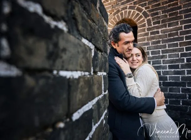 Surprise marriage proposal engagement shooting on Mutianyu Great Wall with ancient bricks and autumn leaves in background