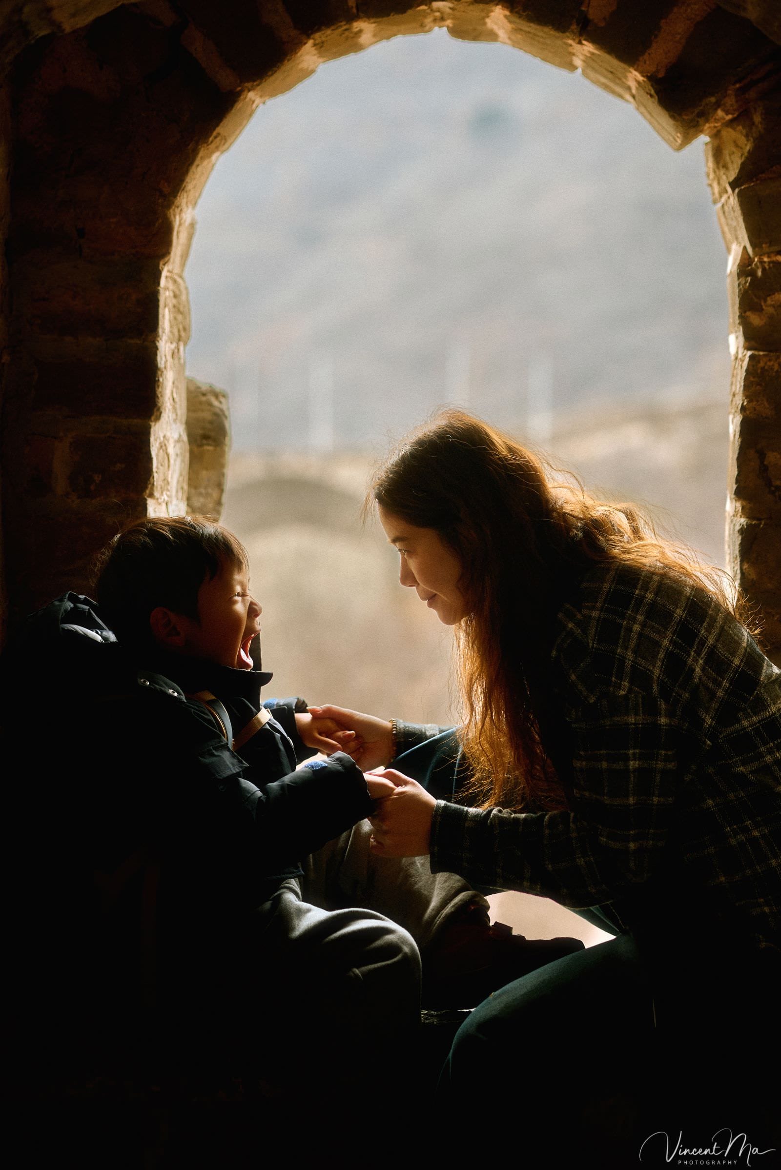 Toddler exploring Mutianyu Great Wall at sunset
