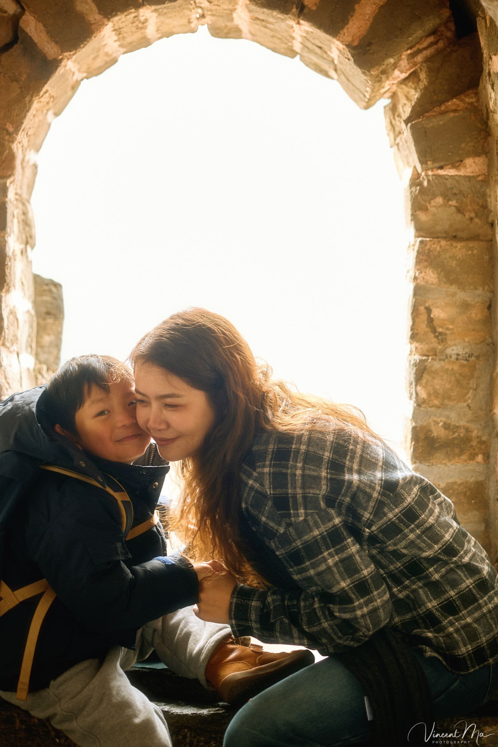 Mother and son exploring the Great Wall in winter