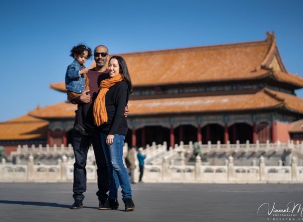 US family of three with toddler laughing in front of the Hall of Supreme Harmony at Forbidden City, blue sky and no tourists.Family photography by Vincent Ma