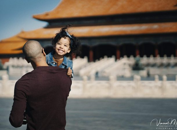 US family of three with toddler laughing in front of the Hall of Supreme Harmony at Forbidden City, blue sky and no tourists.Family photography by Vincent Ma