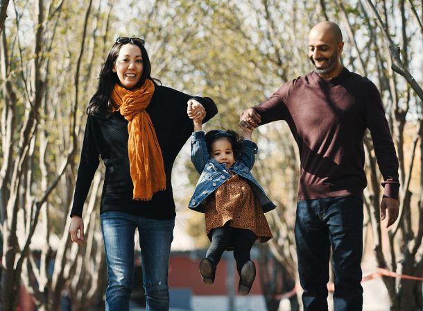 US family of three with toddler laughing in front of the Hall of Supreme Harmony at Forbidden City, blue sky and no tourists.Family photography by Vincent Ma