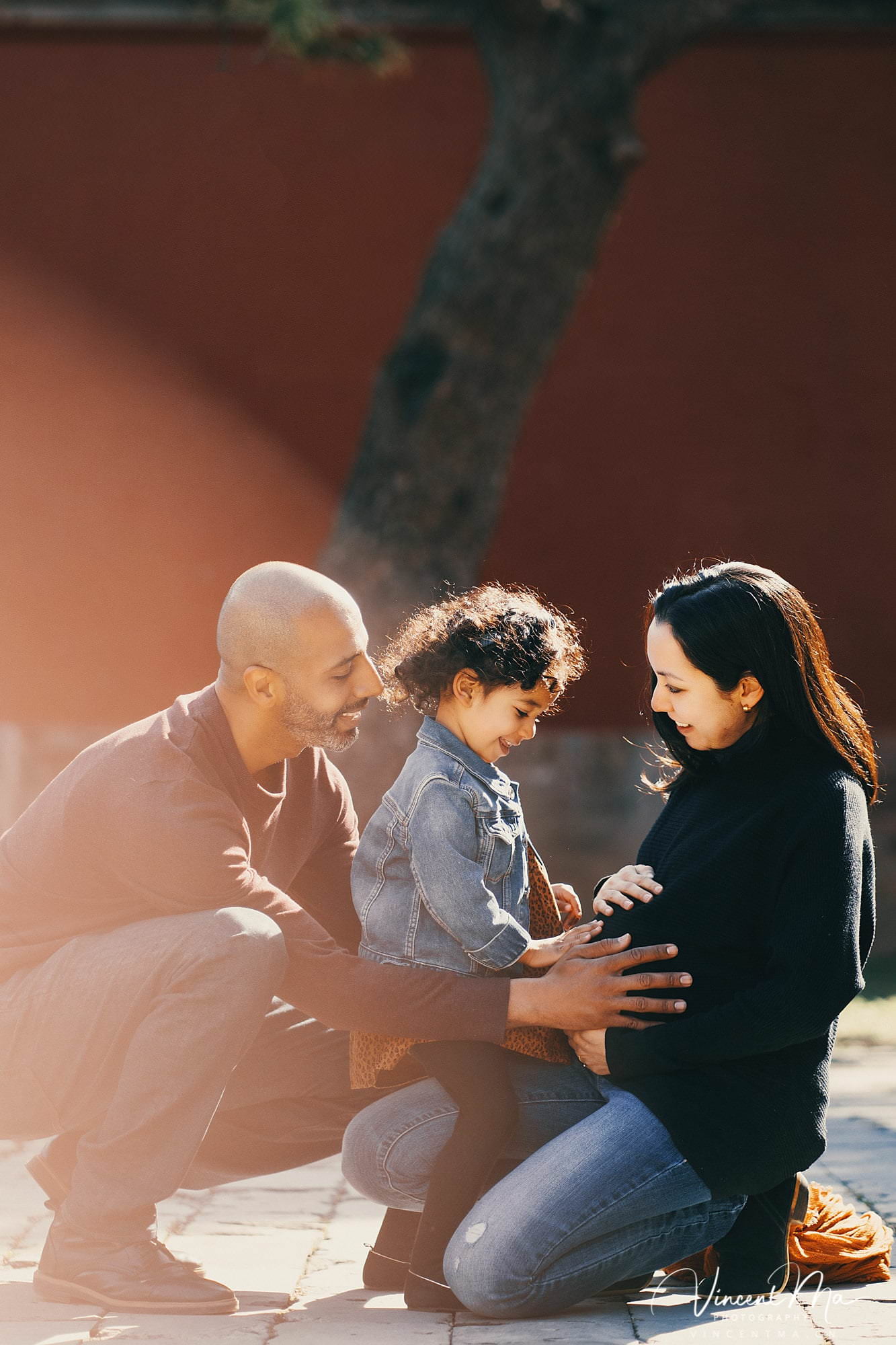 US family of three with toddler laughing in front of the Hall of Supreme Harmony at Forbidden City, blue sky and no tourists.Family photography by Vincent Ma