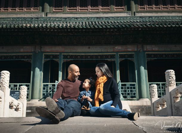 US family of three with toddler laughing in front of the Hall of Supreme Harmony at Forbidden City, blue sky and no tourists.Family photography by Vincent Ma