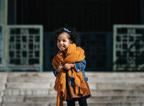 US family of three with toddler laughing in front of the Hall of Supreme Harmony at Forbidden City, blue sky and no tourists.Family photography by Vincent Ma