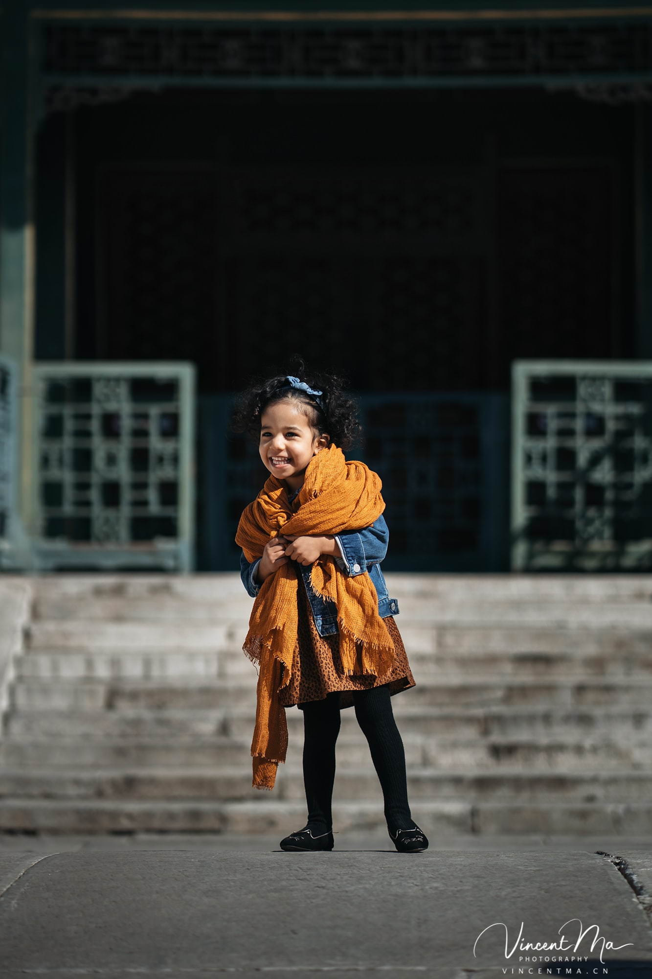US family of three with toddler laughing in front of the Hall of Supreme Harmony at Forbidden City, blue sky and no tourists.Family photography by Vincent Ma