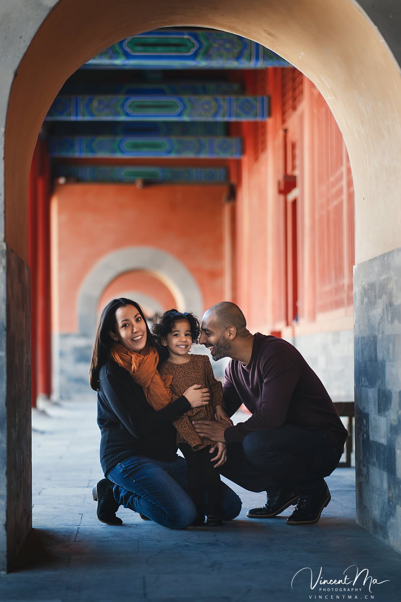 US family of three with toddler laughing in front of the Hall of Supreme Harmony at Forbidden City, blue sky and no tourists.Family photography by Vincent Ma