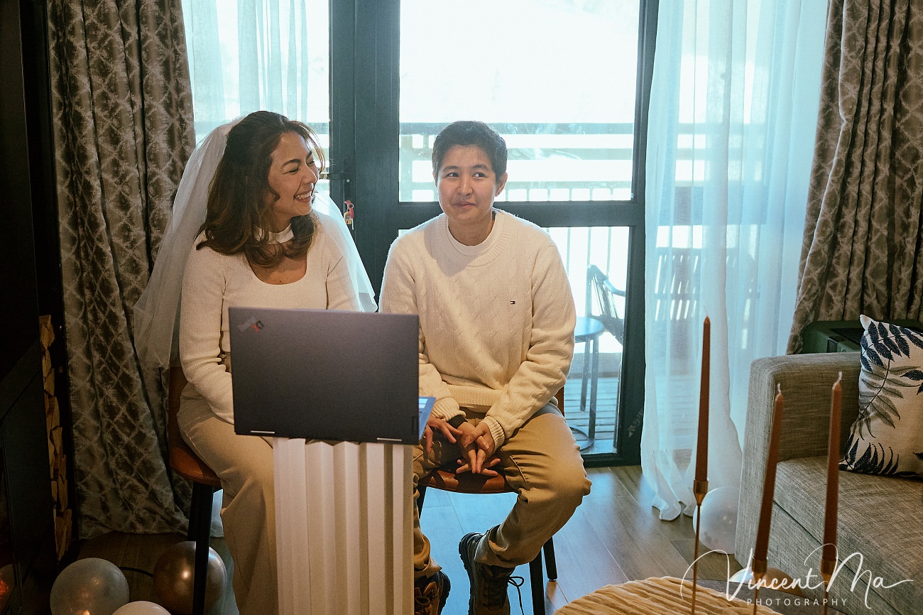 A cinematic and documentary photography series of Claire and April's same-sex winter elopement at Chongli Ski Resort, China. This minimalist wedding strips away traditional routines, featuring snowboarding in powder snow, intimate moments with their golden retrievers, and a legal online marriage ceremony via the Courtly platform by a cozy fireplace. Captured with a non-intrusive, lifestyle storytelling approach by Vincent Ma Visuals, a trusted LGBTQ-friendly photographer based in Beijing.