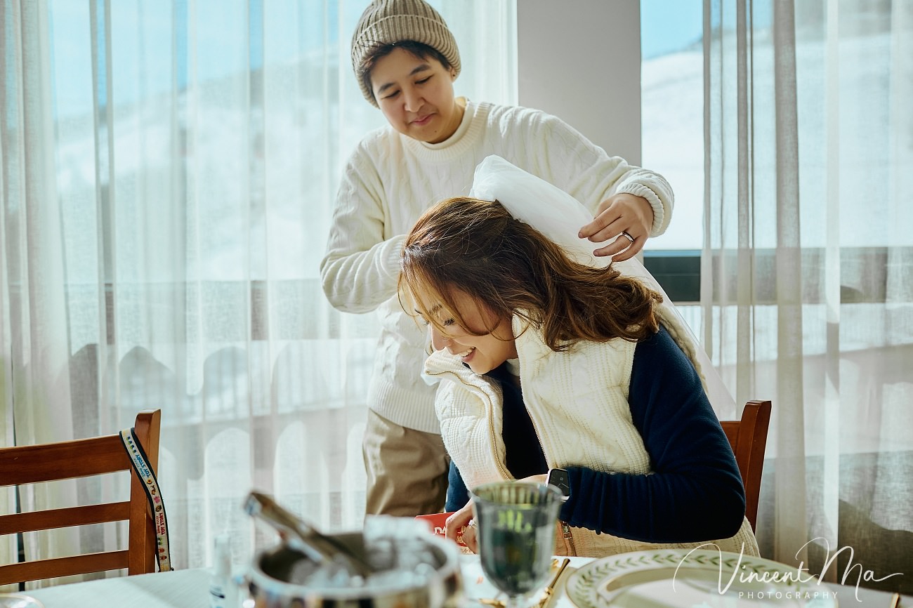 A cinematic and documentary photography series of Claire and April's same-sex winter elopement at Chongli Ski Resort, China. This minimalist wedding strips away traditional routines, featuring snowboarding in powder snow, intimate moments with their golden retrievers, and a legal online marriage ceremony via the Courtly platform by a cozy fireplace. Captured with a non-intrusive, lifestyle storytelling approach by Vincent Ma Visuals, a trusted LGBTQ-friendly photographer based in Beijing.