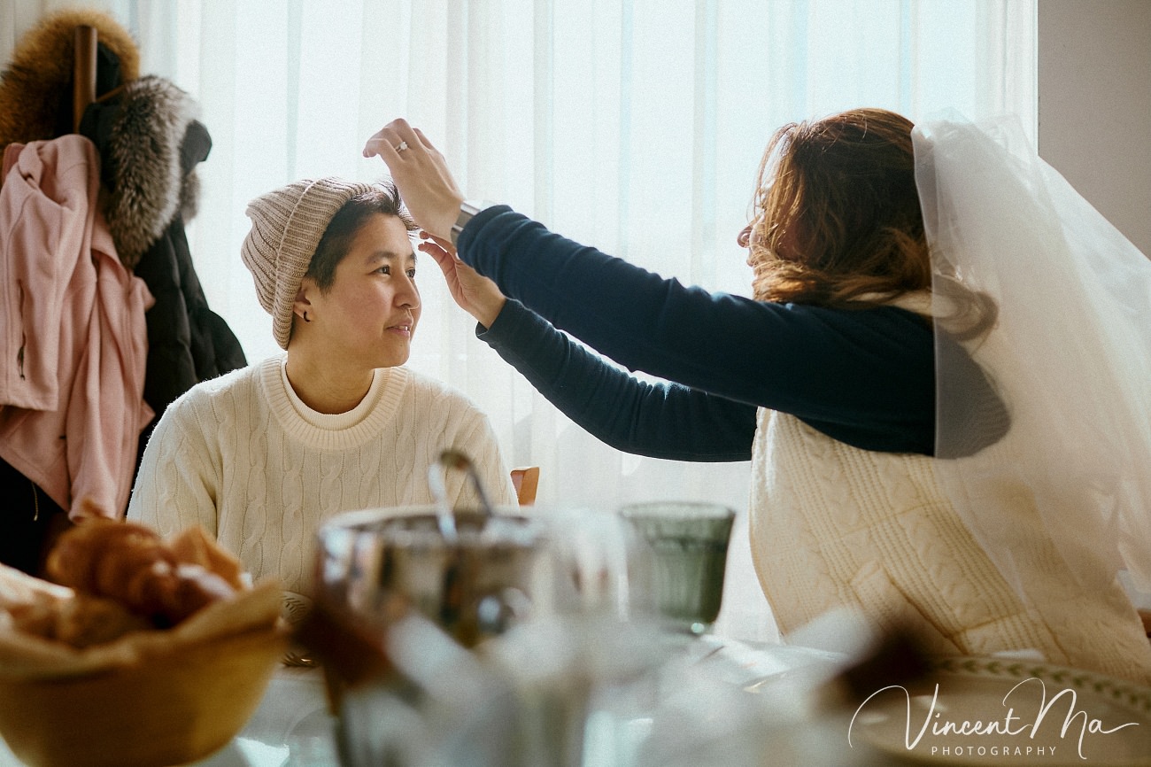 A cinematic and documentary photography series of Claire and April's same-sex winter elopement at Chongli Ski Resort, China. This minimalist wedding strips away traditional routines, featuring snowboarding in powder snow, intimate moments with their golden retrievers, and a legal online marriage ceremony via the Courtly platform by a cozy fireplace. Captured with a non-intrusive, lifestyle storytelling approach by Vincent Ma Visuals, a trusted LGBTQ-friendly photographer based in Beijing.