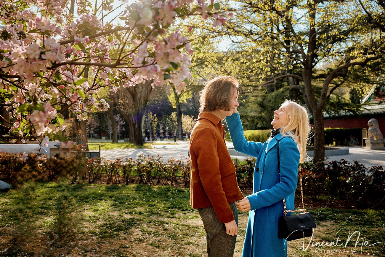 Mother and son from Germany enjoying spring blossoms at Ritan Park Beijing photoshoot