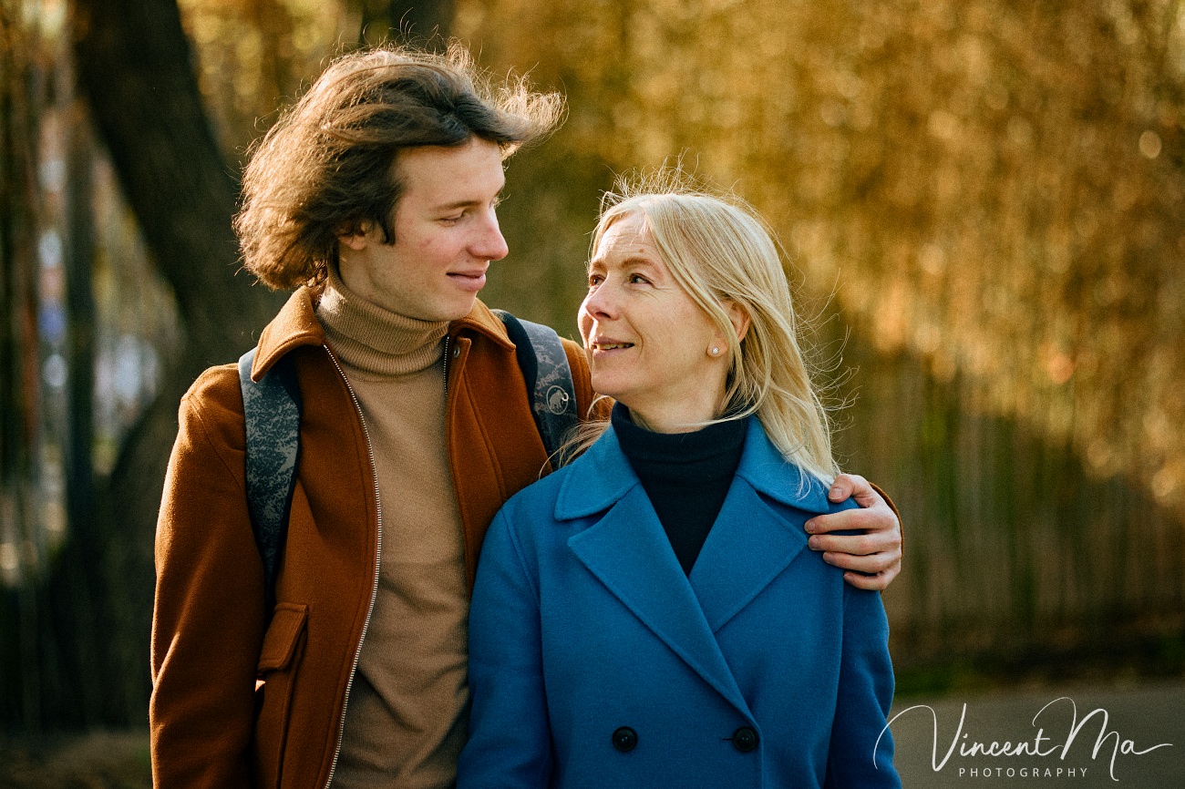 Family travel photography in Beijing featuring traditional red walls and golden hour sunlight.