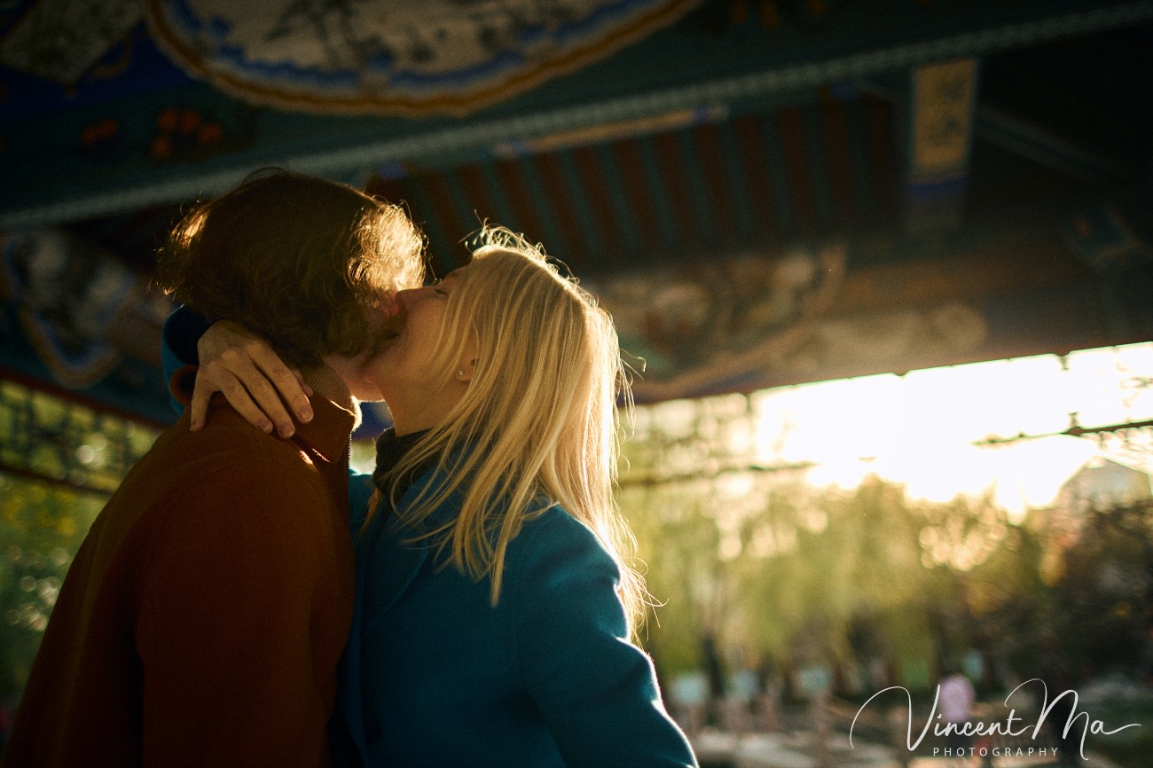 Family travel photography in Beijing featuring traditional red walls and golden hour sunlight.