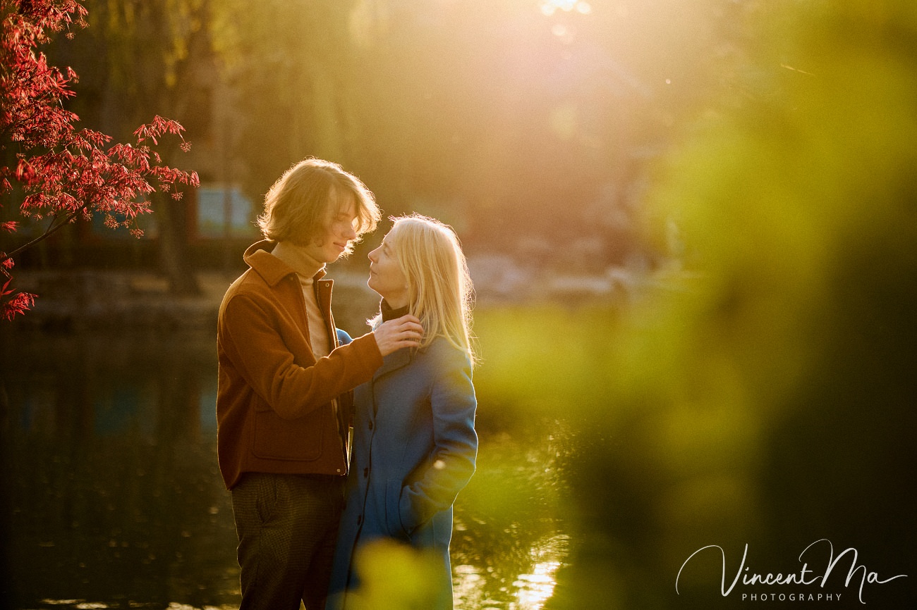 Family travel photography in Beijing featuring traditional red walls and golden hour sunlight.