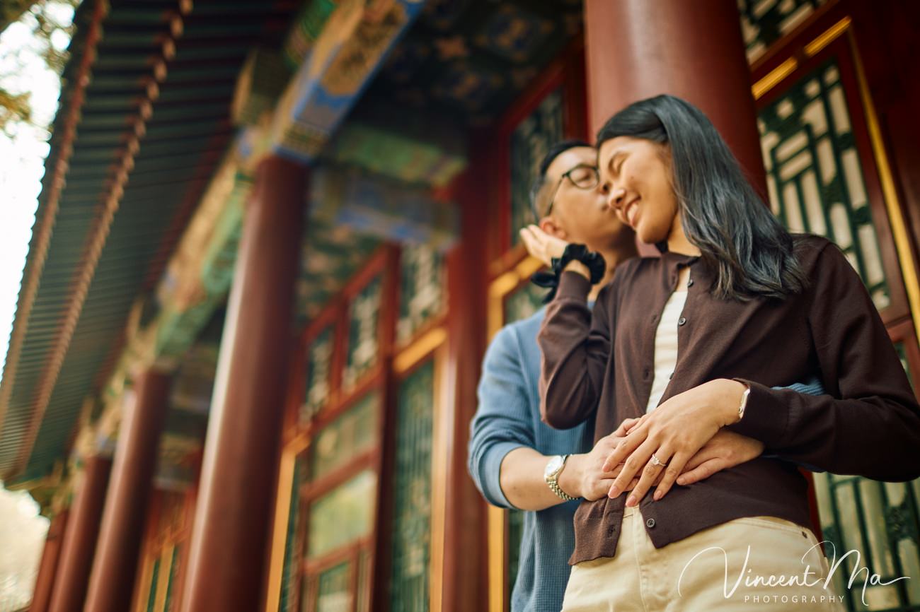 Close-up of an engagement ring held against a backdrop of spring magnolias and cherry blossoms at the Summer Palace, Beijing. Symbol of love in the heart of China.